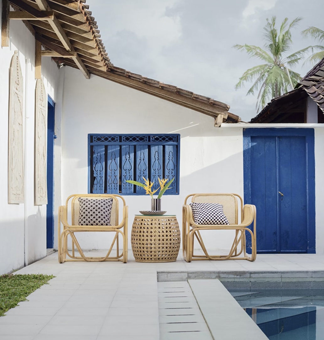 White and blue house with pool.