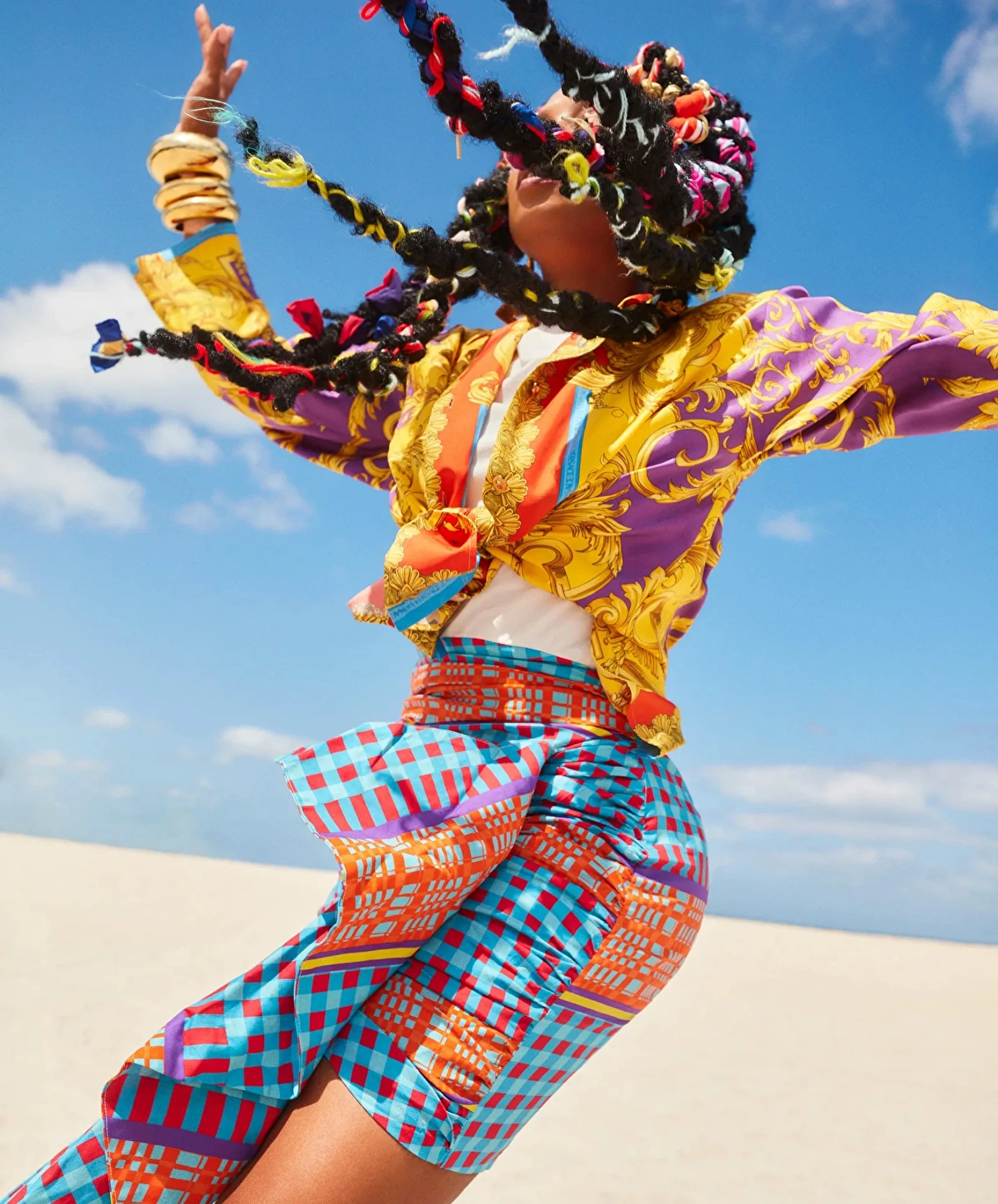 Model jumping while wearing a colorful outfit from Desigual fashion collection_Branding
