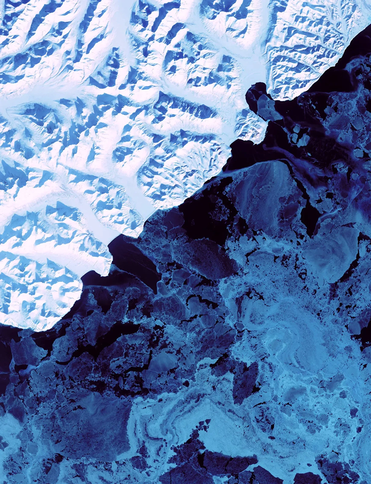 A photo of the ocean, showing a section of ice and a section of open water